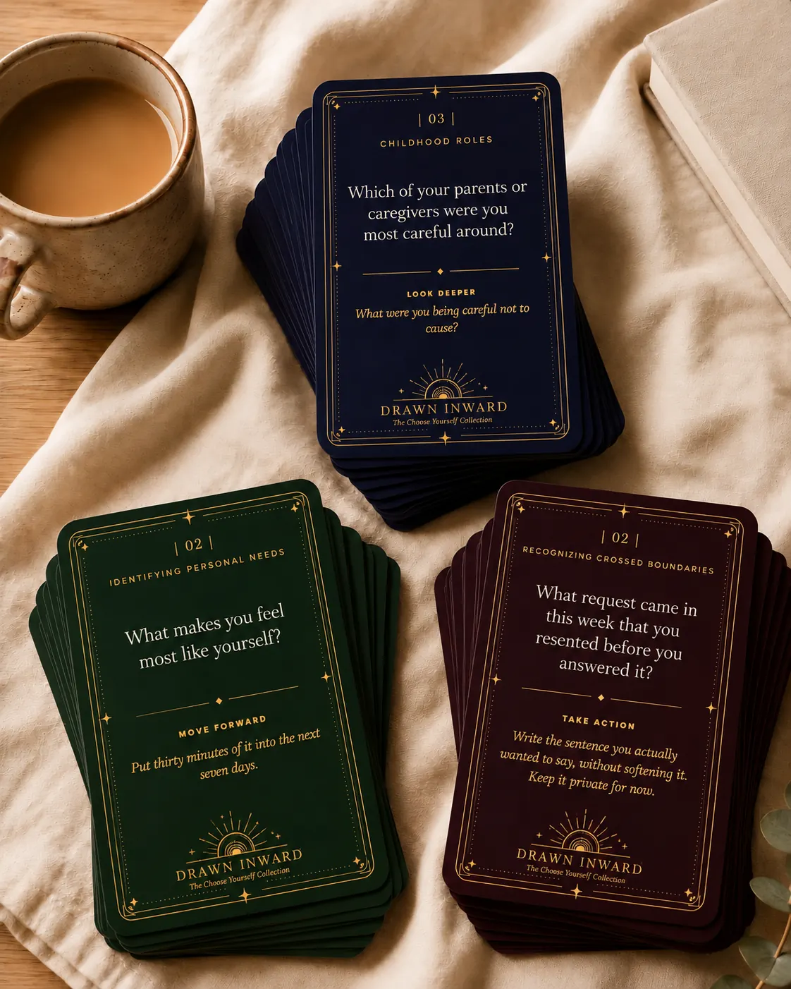 The Complete Collection — three Drawn Inward card stacks with coffee